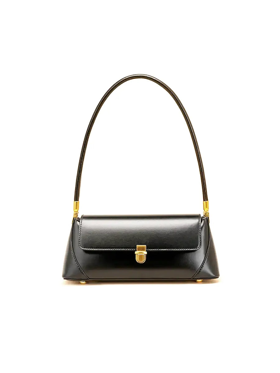 Black handbag with gold accents on a white background