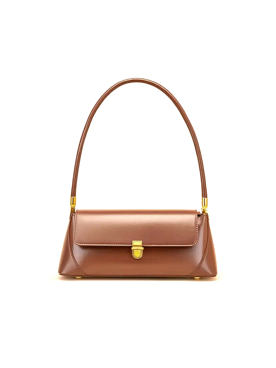 Brown handbag with gold accents on a white background