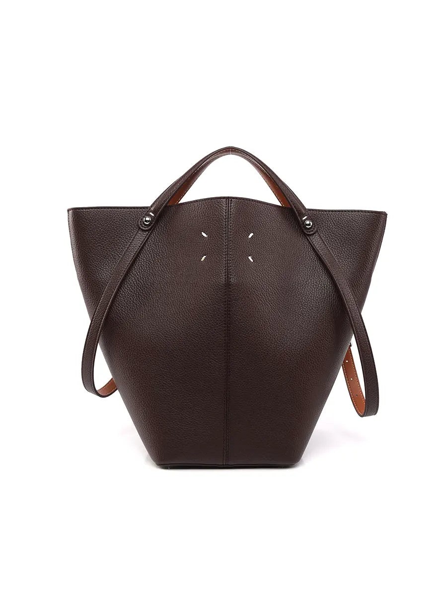 Brown leather handbag with a strap on a white background