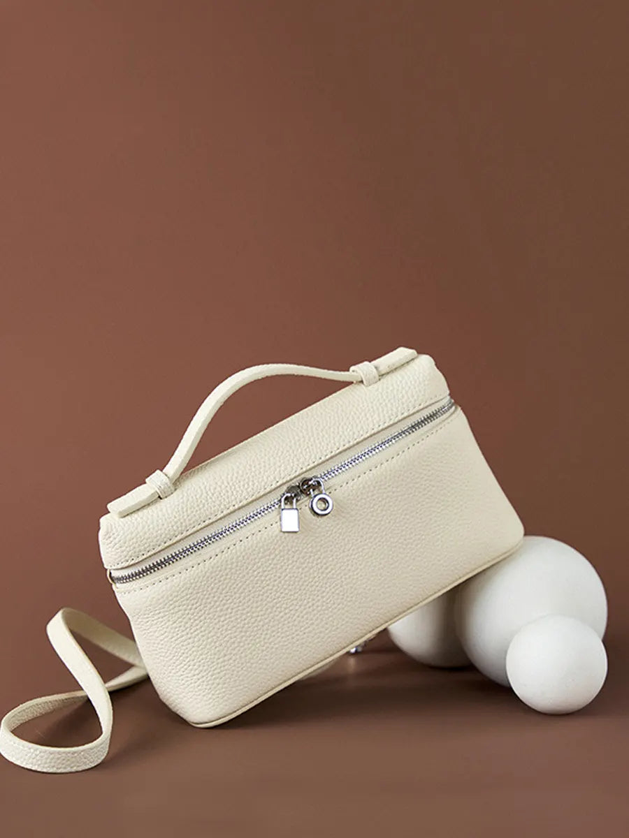 Beige handbag with a zipper on a brown background
