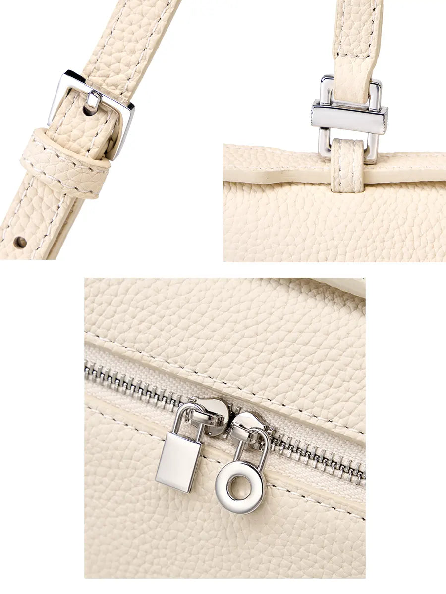 Close-up of a beige handbag with a strap and zipper details on a white background
