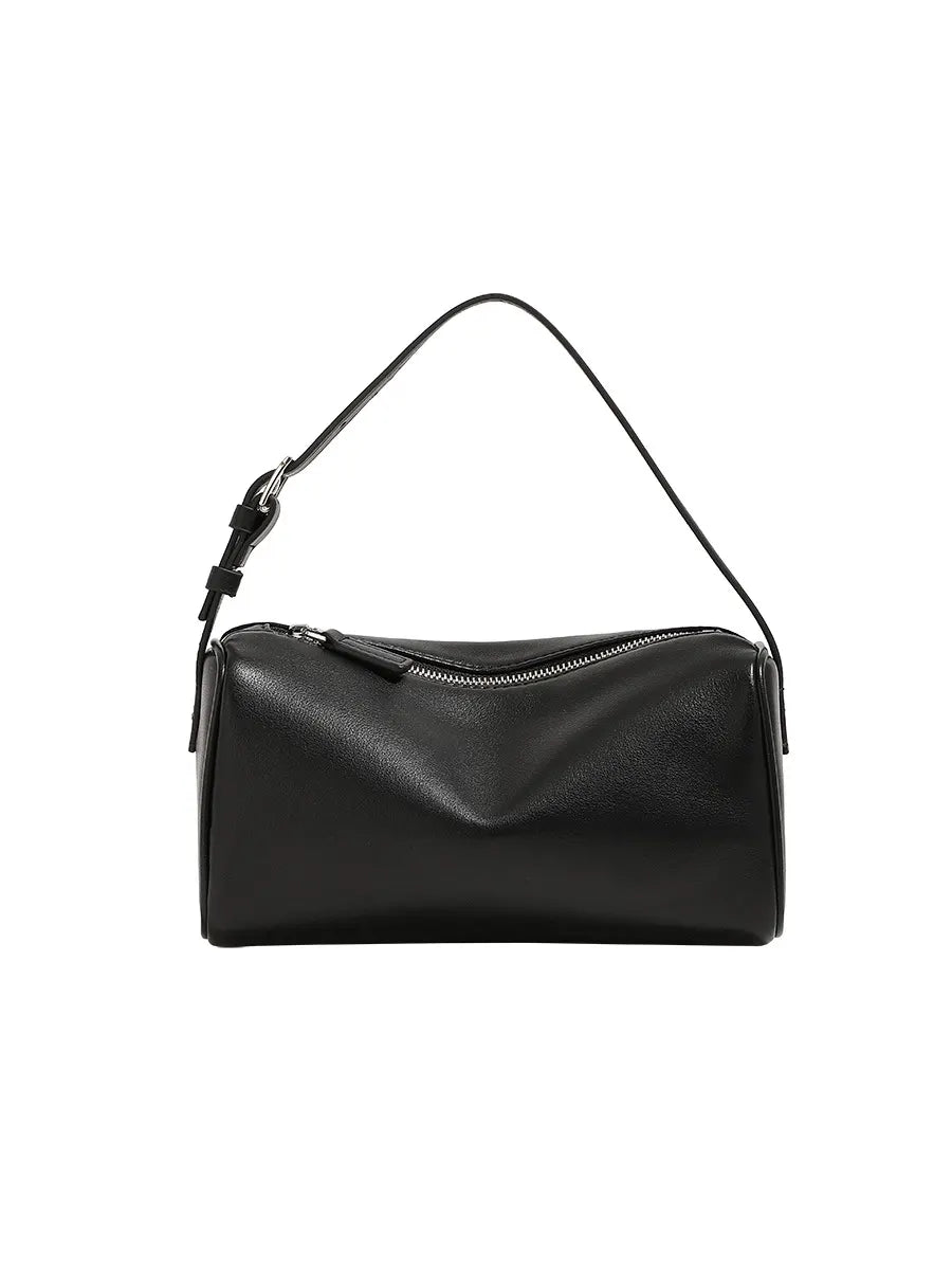 Black handbag with a strap on a white background