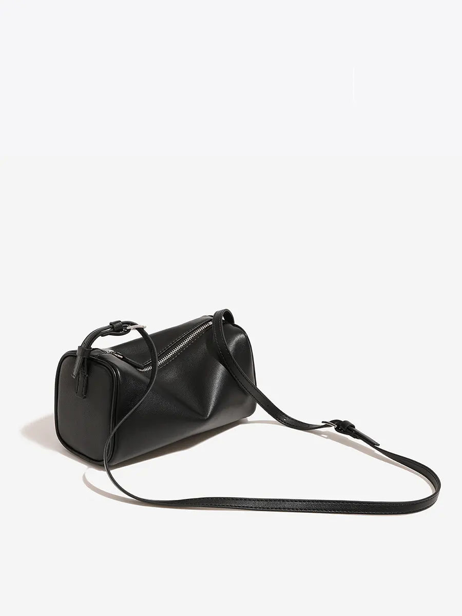 Black handbag with a strap on a white background