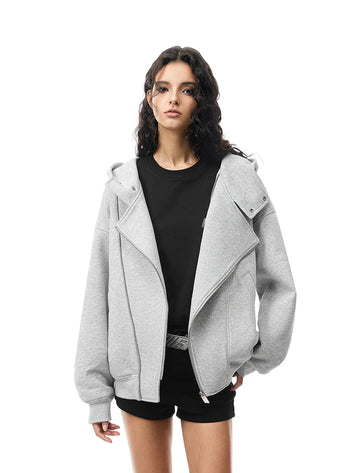 Woman wearing a gray jacket over a black top on a white background