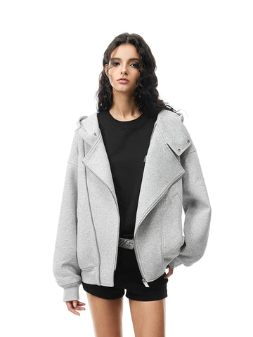 Woman wearing a gray jacket over a black top on a white background