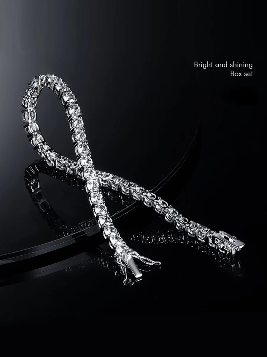 Silver bracelet with clear stones on a black background