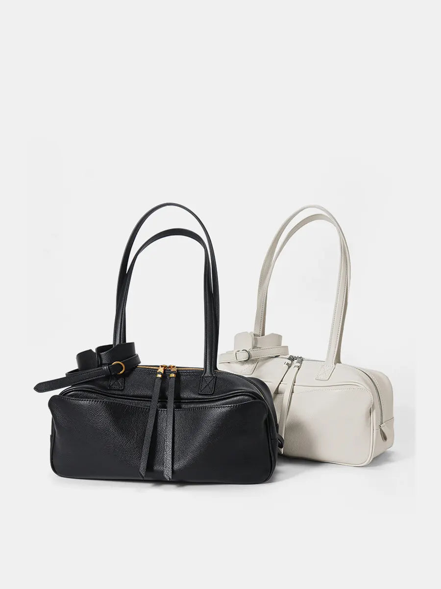 Black and white handbags on a light gray background