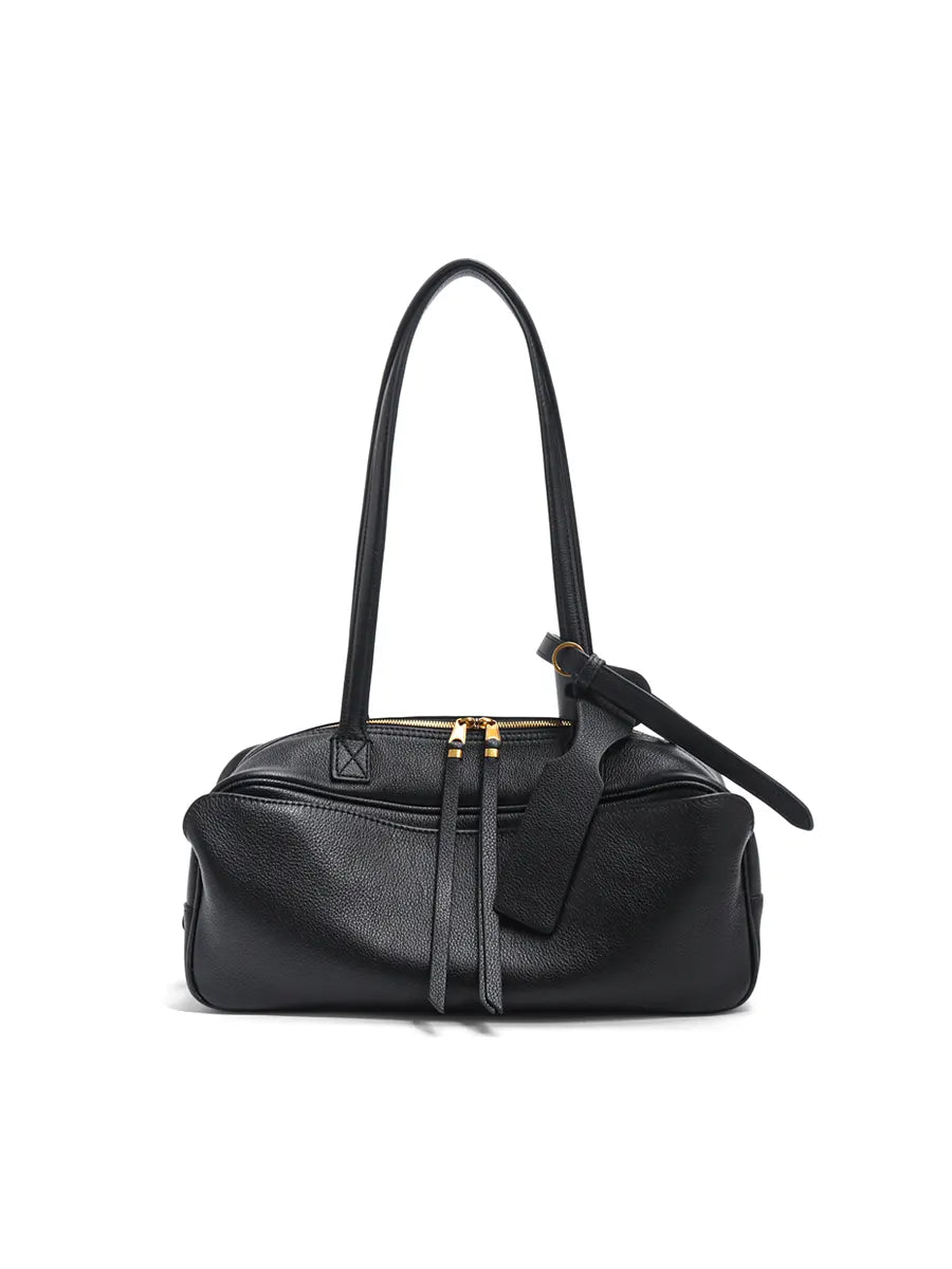 Black handbag with gold accents on a white background