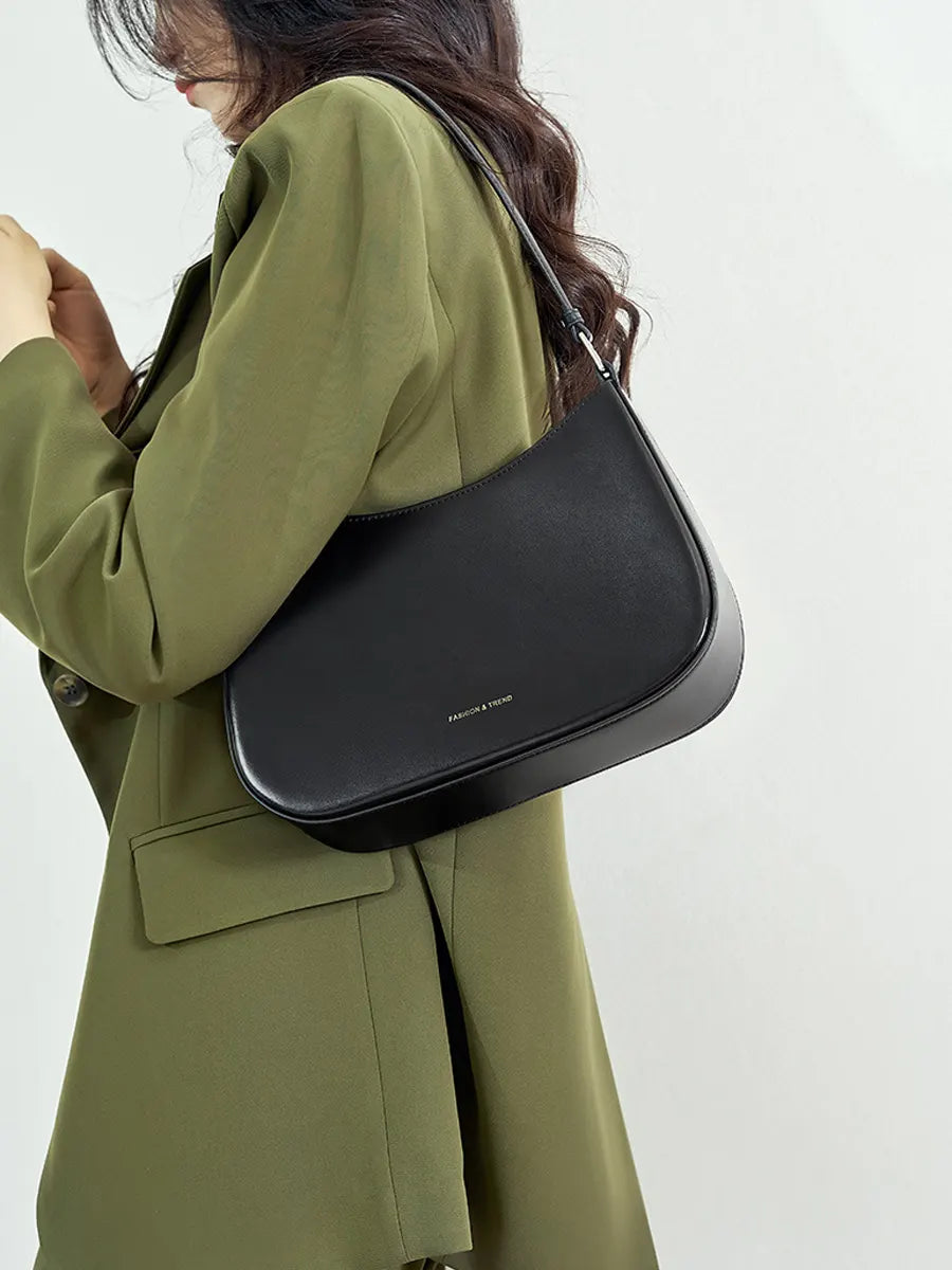 Person wearing a green coat with a black shoulder bag on a white background