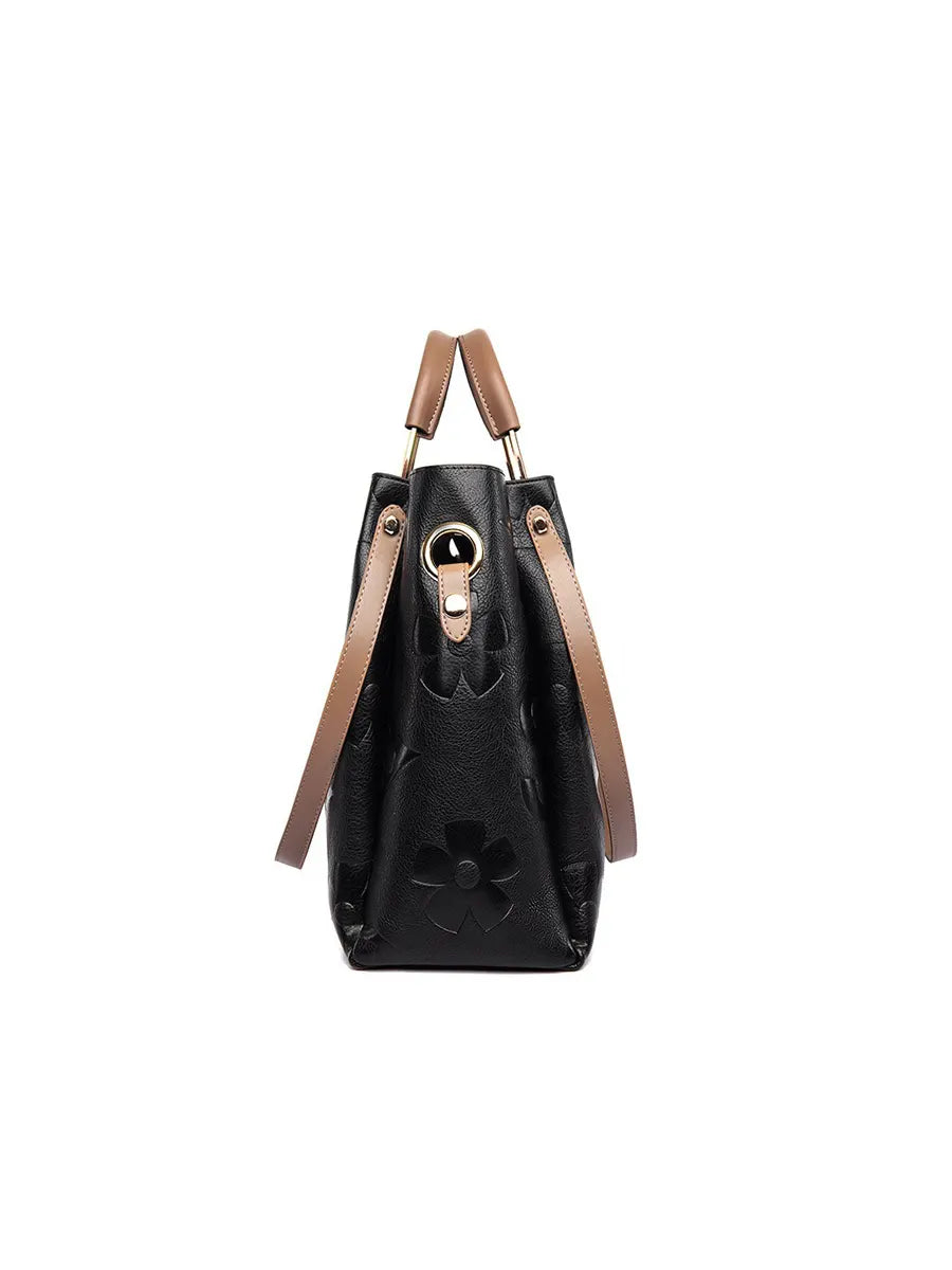 Black handbag with brown straps on a white background