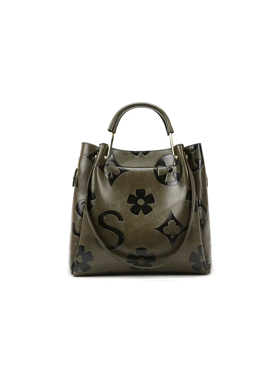 Green handbag with floral patterns on a white background