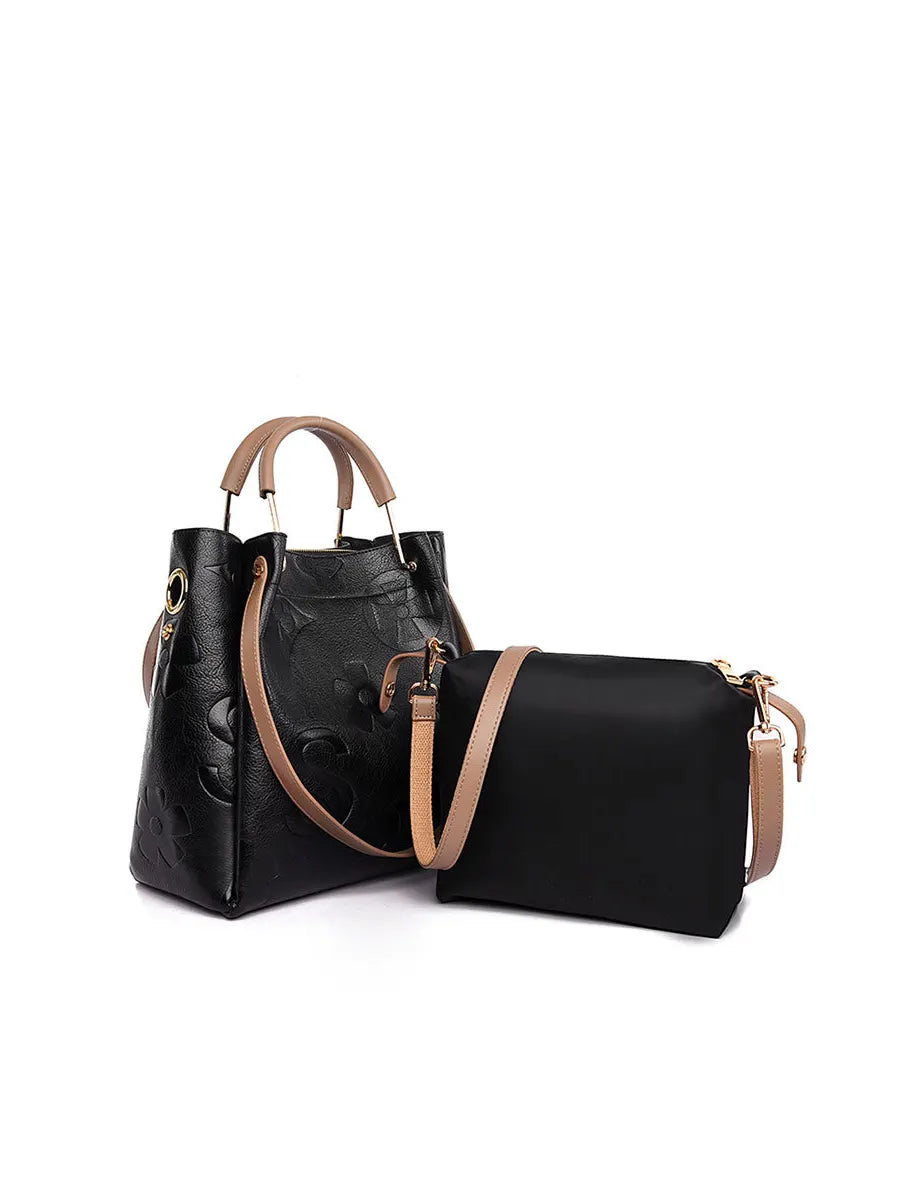 Black handbag with brown accents on a white background