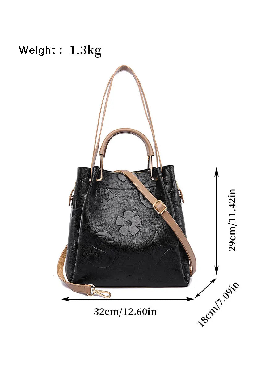 Black handbag with brown straps and floral design, shown with measurements and weight on a white background.