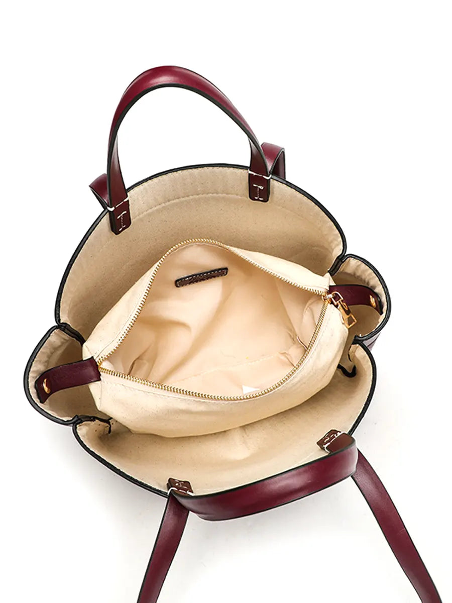 Open handbag with beige interior on a white background