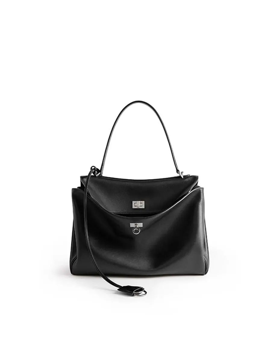 Black handbag with a strap on a white background