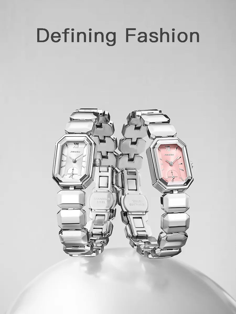 Two silver watches with pink faces on a gray background, featuring the text 'Defining Fashion'.