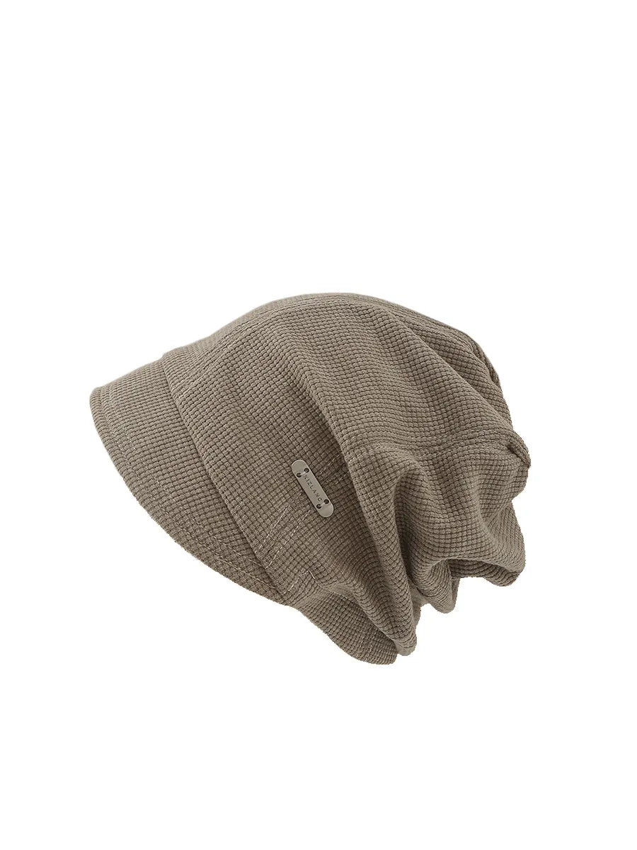 Beige knit beanie on a white background