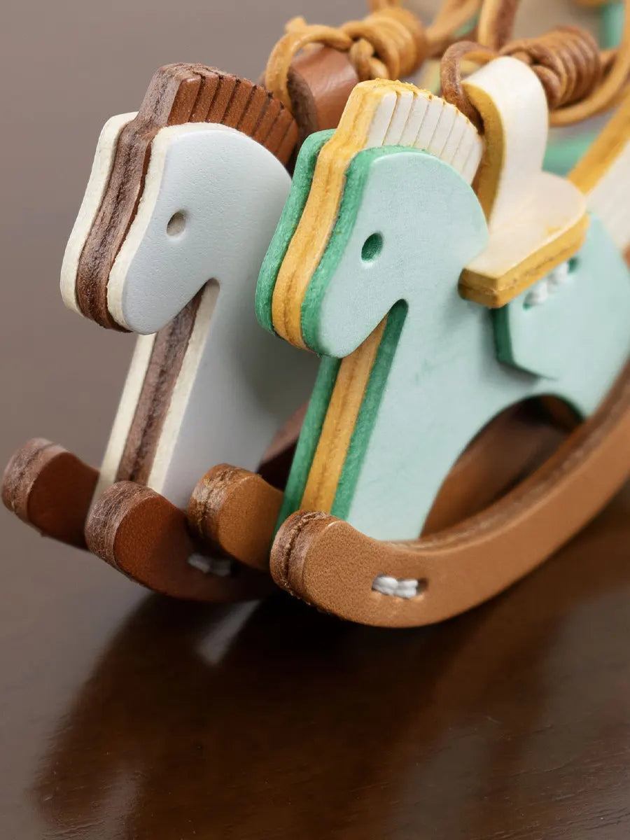 Wooden toy horse with a rope, on a brown background