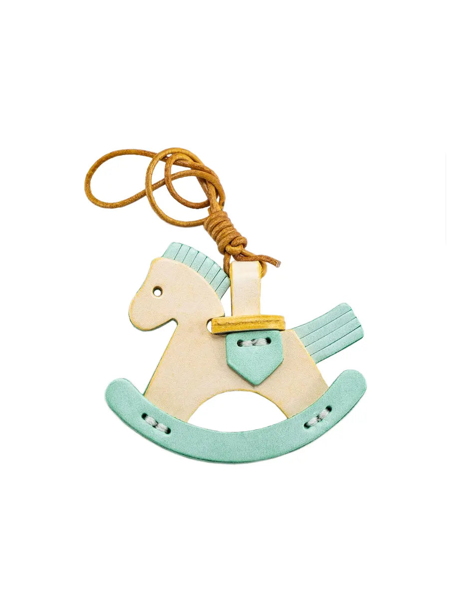 Wooden rocking horse toy with a yellow rope on a white background