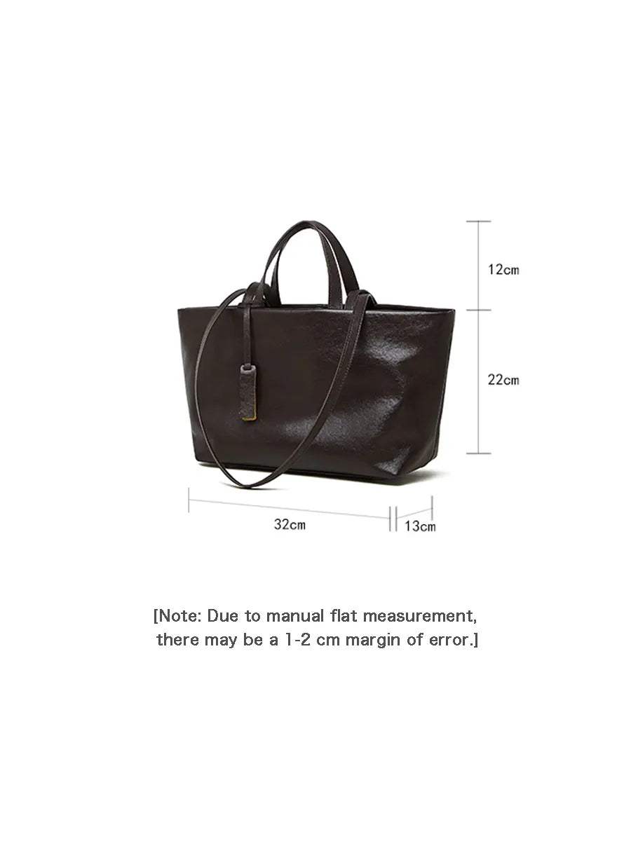 Brown leather handbag with dimensions on a white background