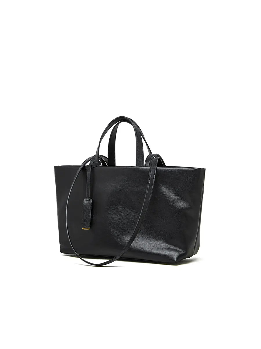 Black leather tote bag on a white background