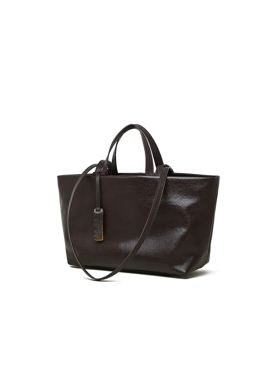 Brown leather tote bag on a white background