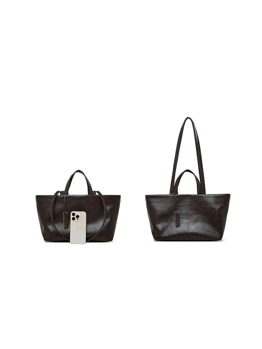 Two black handbags on a white background