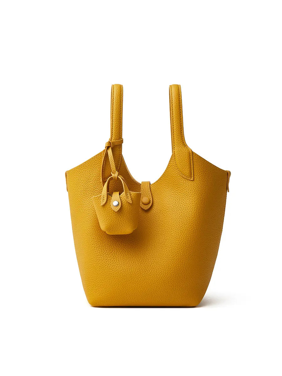 Yellow handbag with a smaller matching pouch on a white background