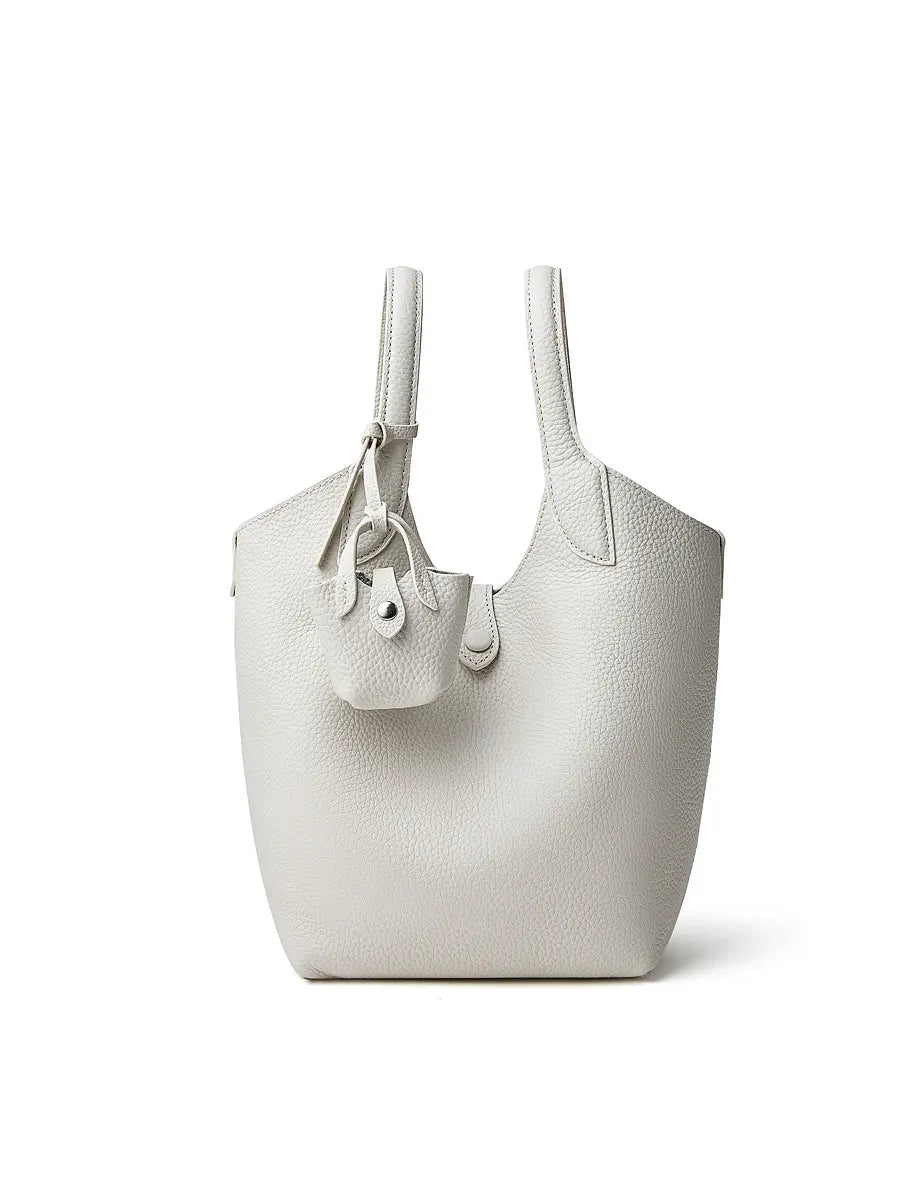 White handbag with a small pouch on a white background