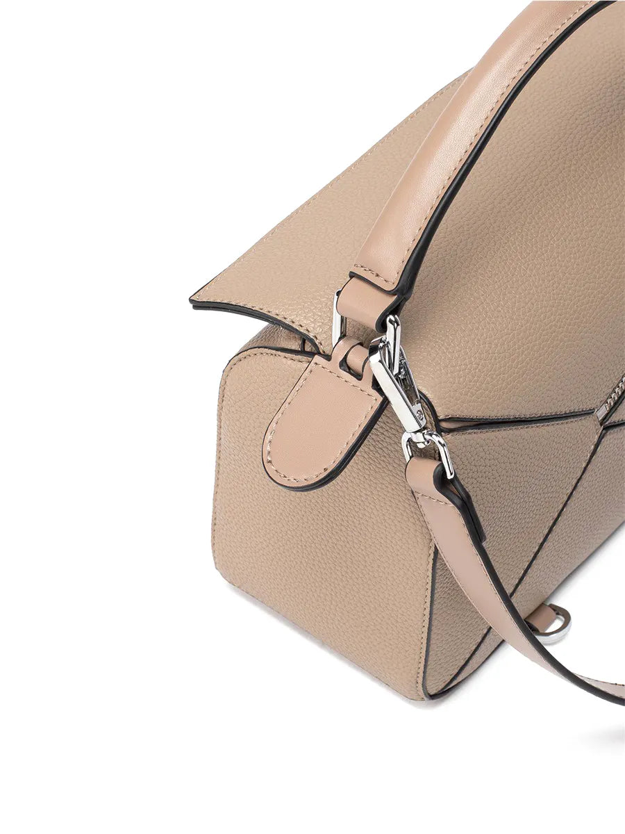 Beige handbag with a silver zipper on a white background