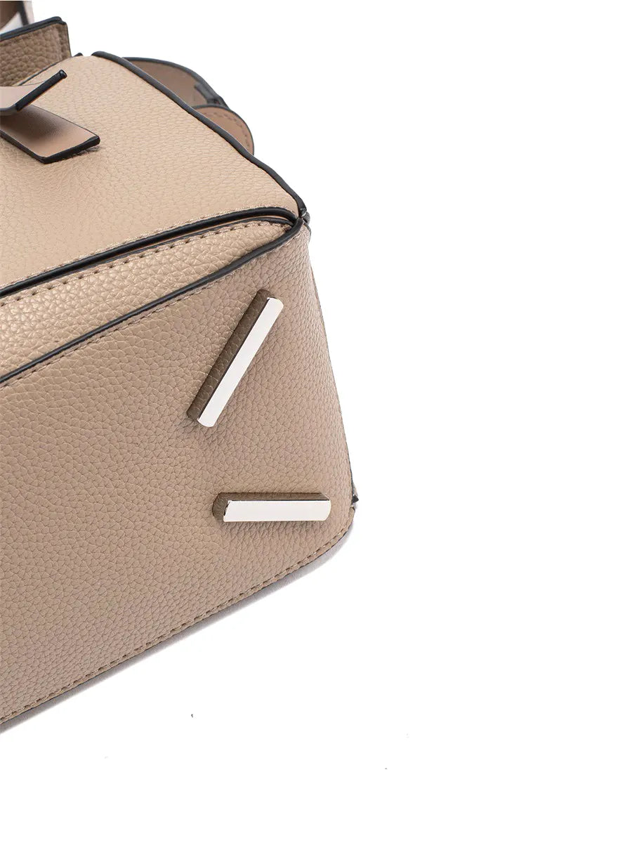 Close-up of a beige handbag with metallic accents on a white background