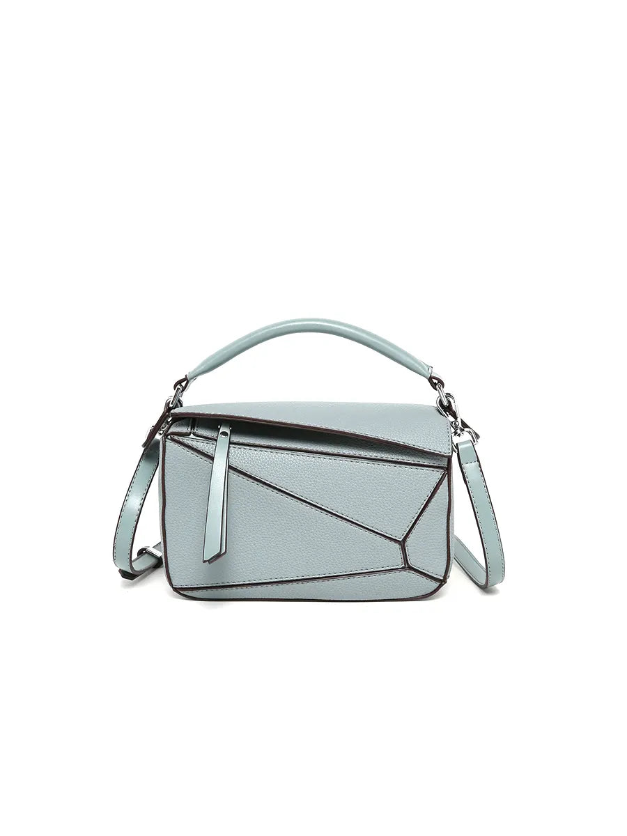 Light blue handbag with geometric design on a white background