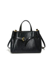 Black woven handbag with a strap on a white background