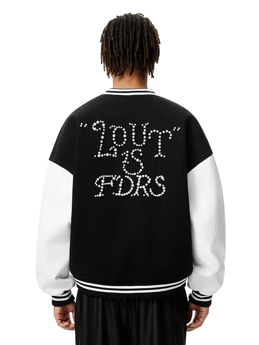 Person wearing a black and white varsity jacket with text on the back against a white background