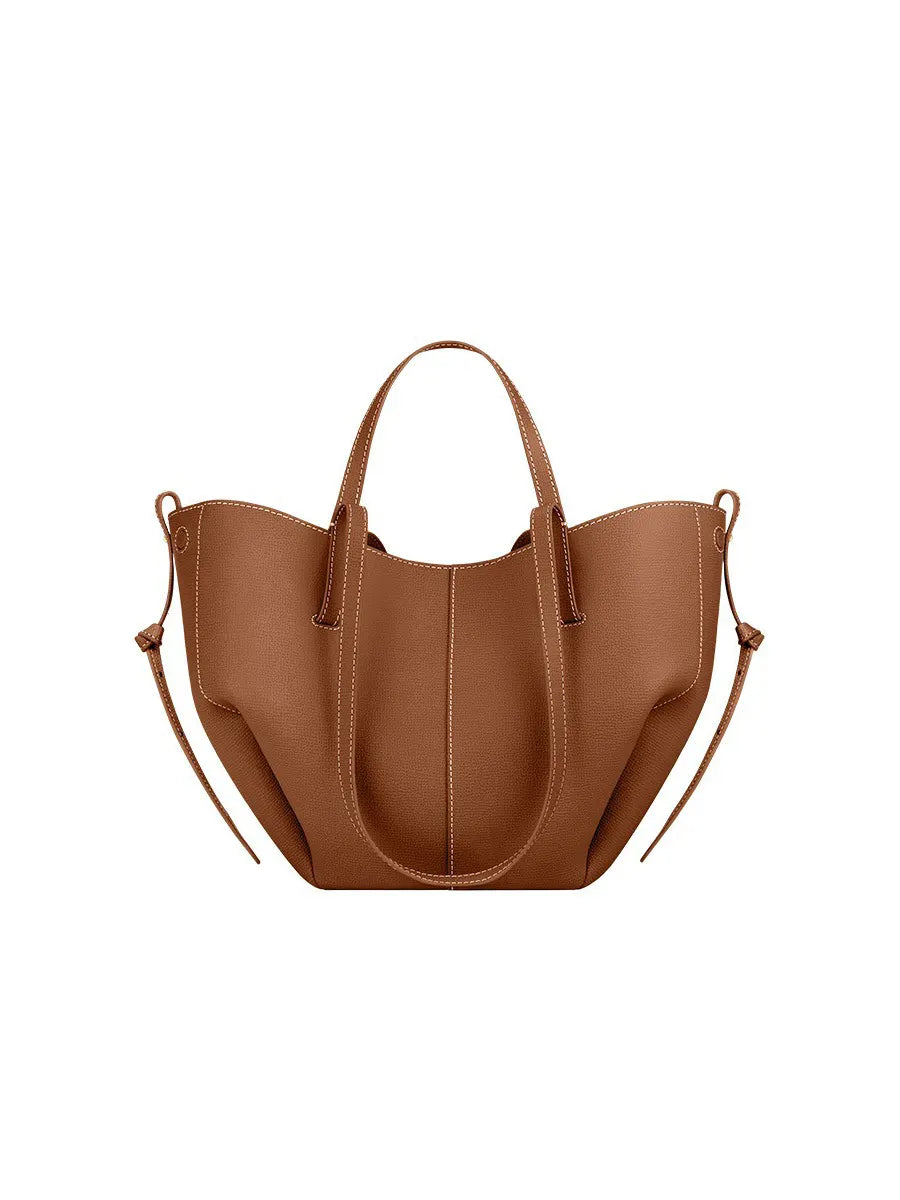 Brown handbag with shoulder strap on a white background