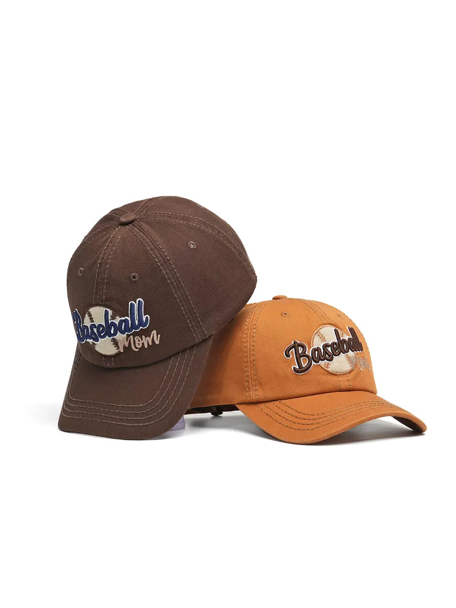 Two baseball caps, one brown and one orange, on a white background