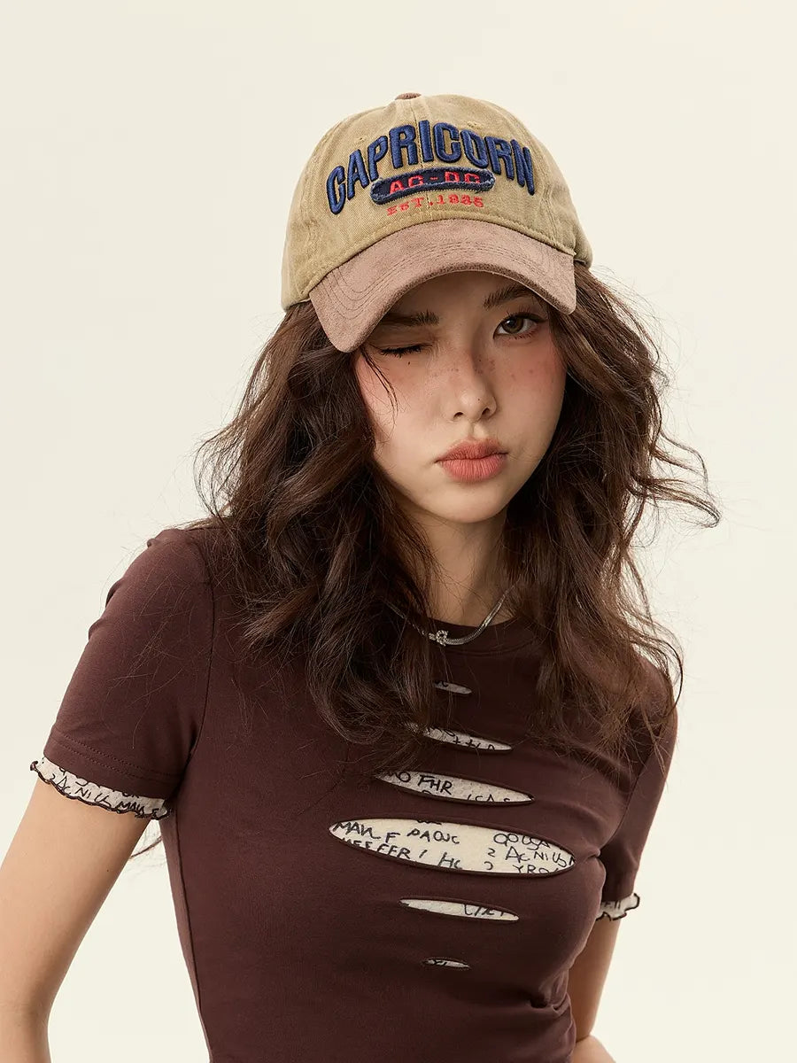 Woman wearing a brown cap and t-shirt with text on a beige background