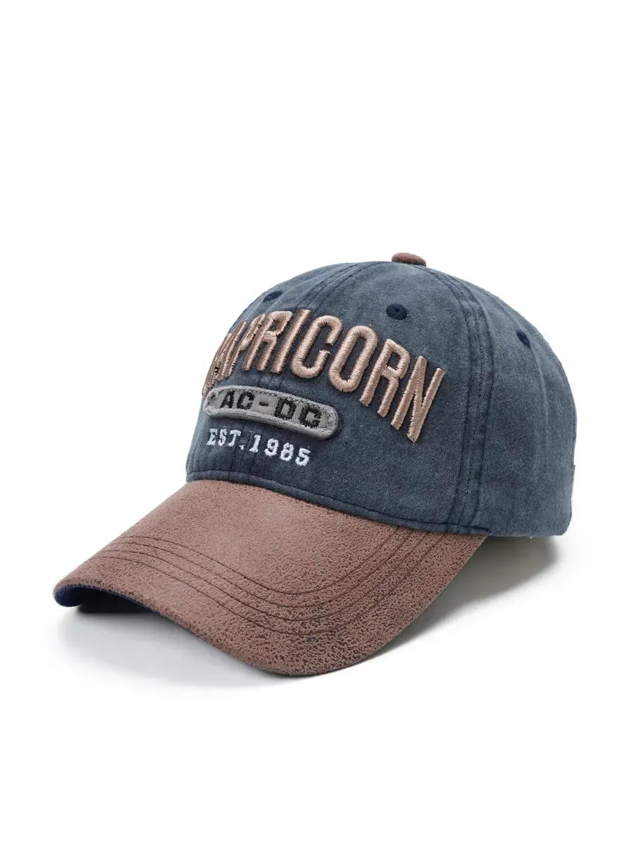Blue and brown cap with 'Capricorn' branding on a white background