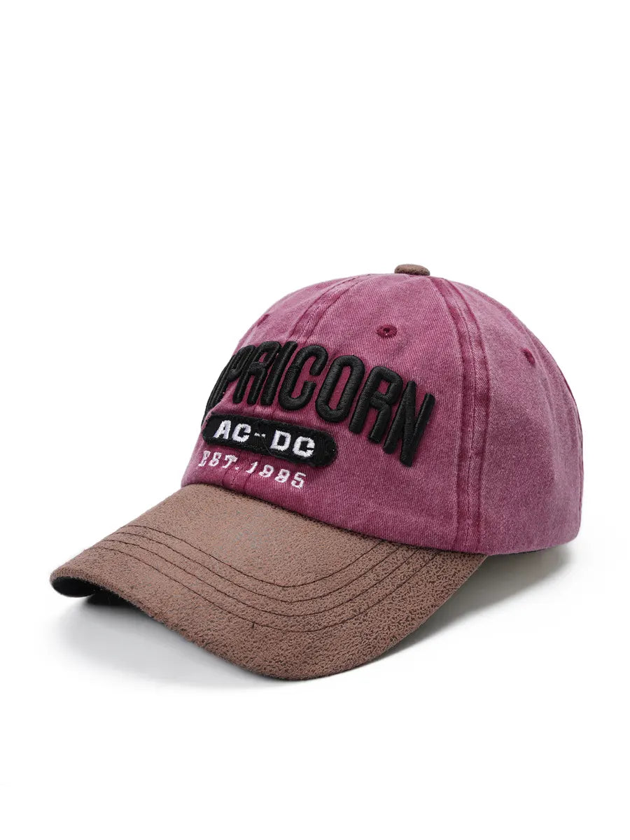 Pink and brown cap with 'AC/DC' branding on a white background
