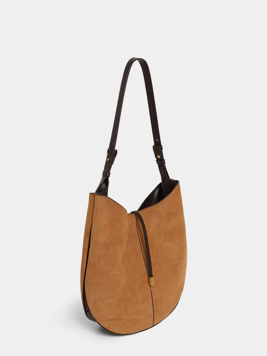 Brown handbag with black accents on a white background