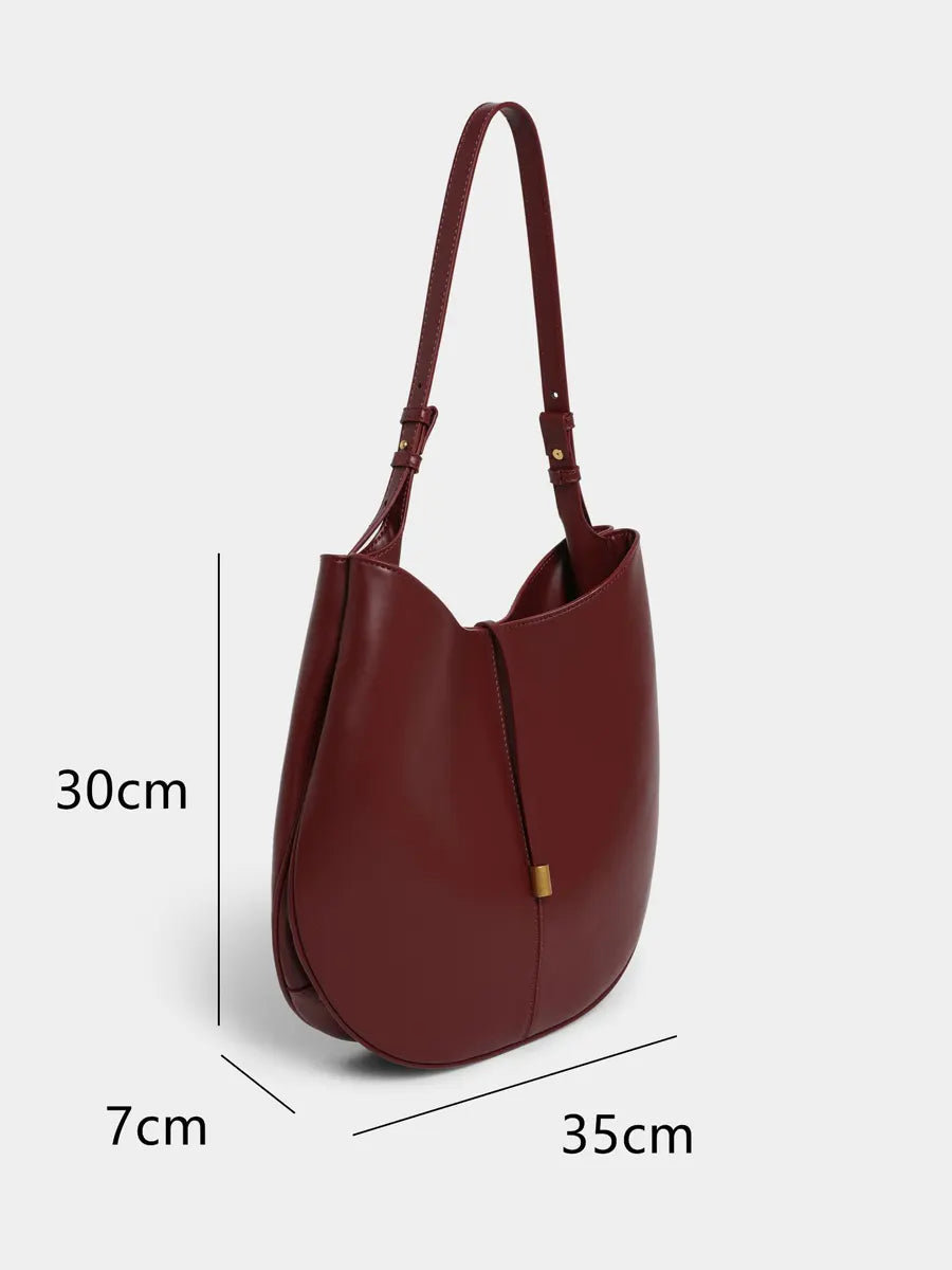 Brown handbag with measurements on a white background