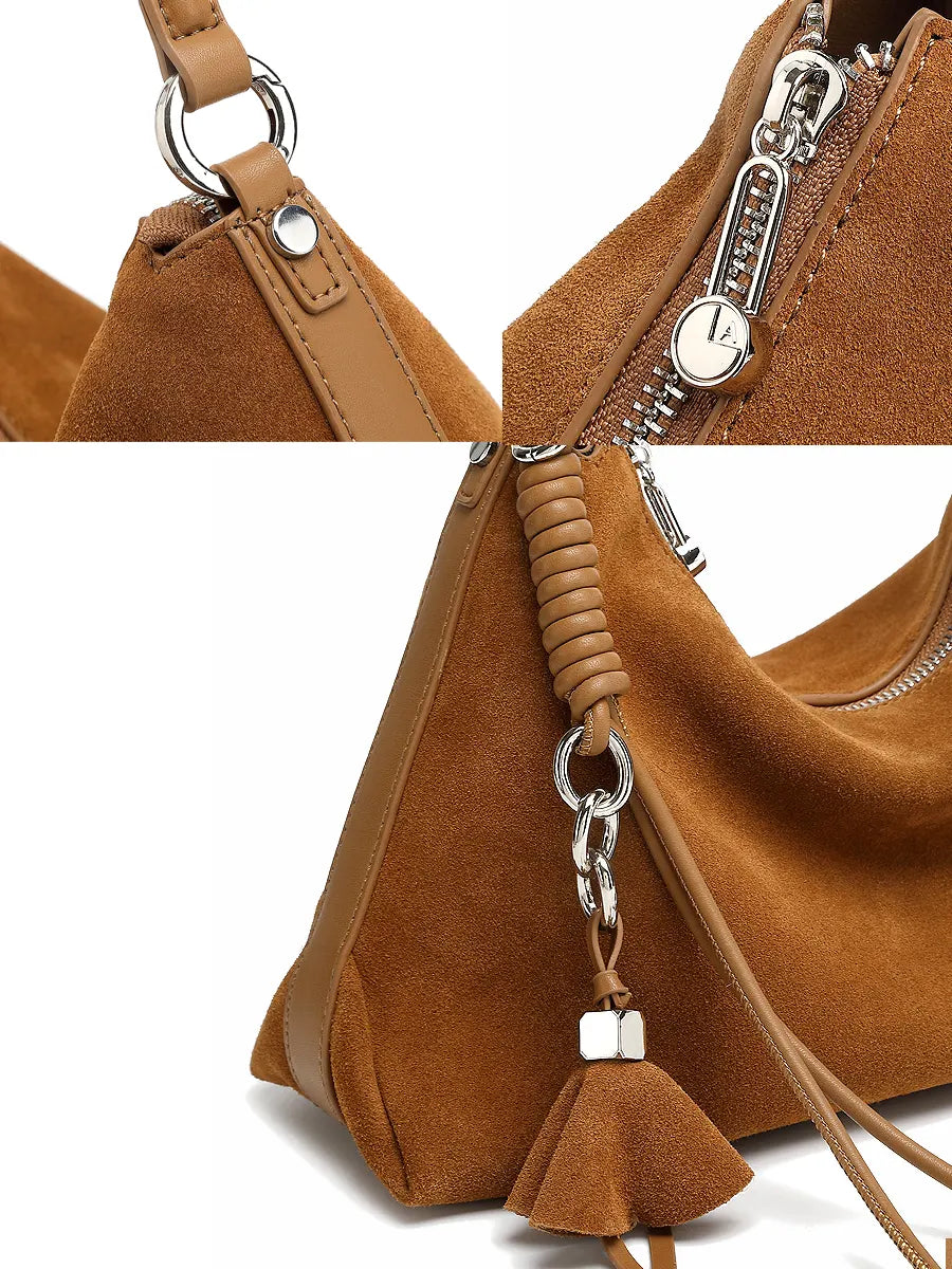 Brown suede handbag with a keychain tassel on a white background
