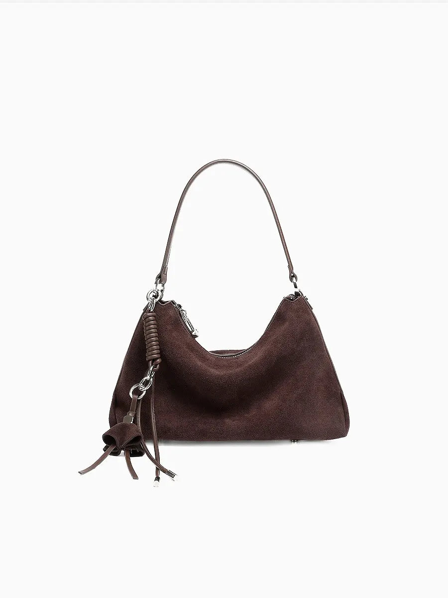 Brown handbag with a strap on a white background
