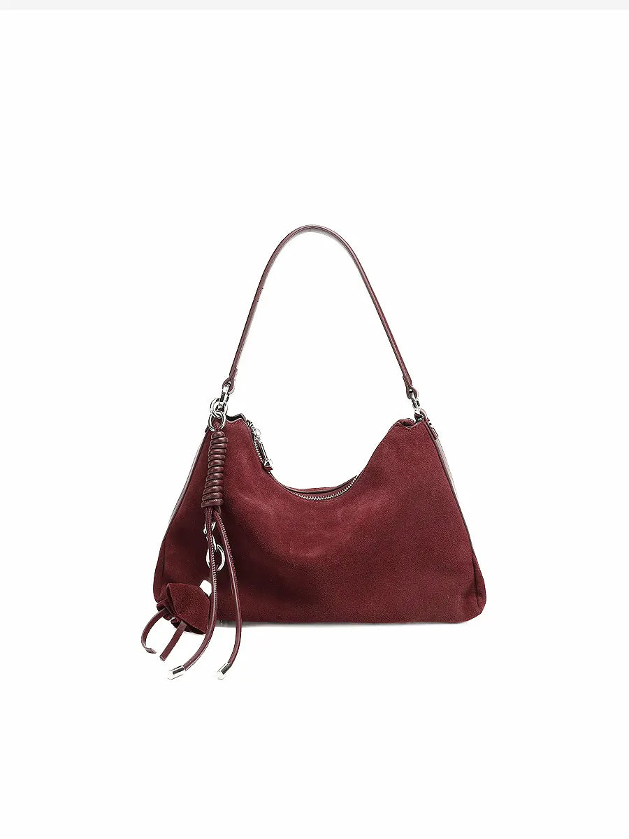 Red handbag with a strap on a white background