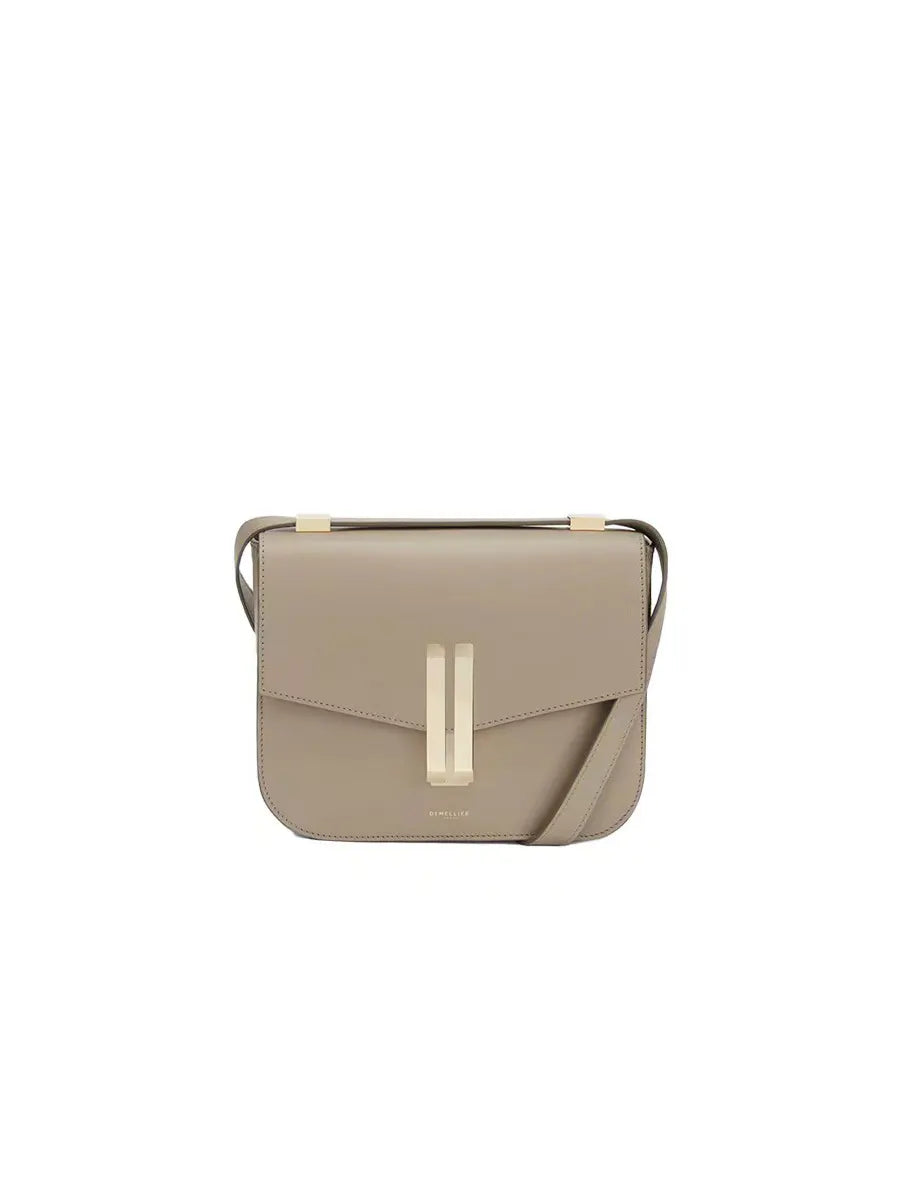 Beige handbag with a gold clasp on a white background