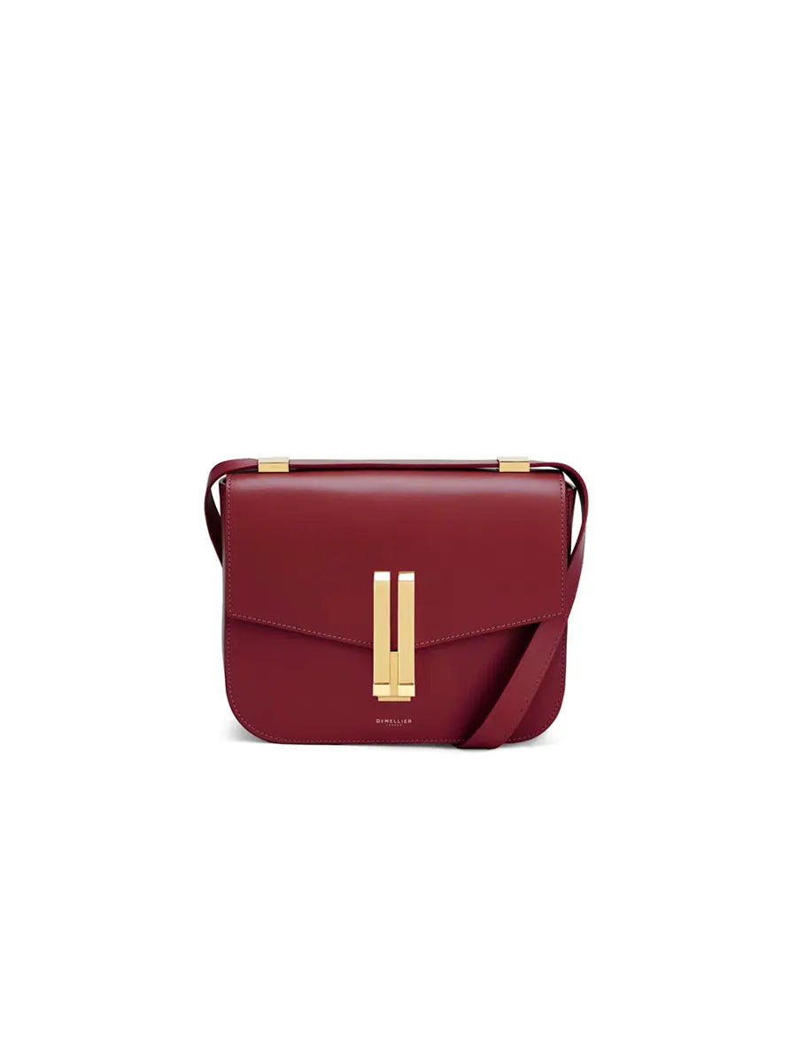 Red handbag with gold clasp on a white background